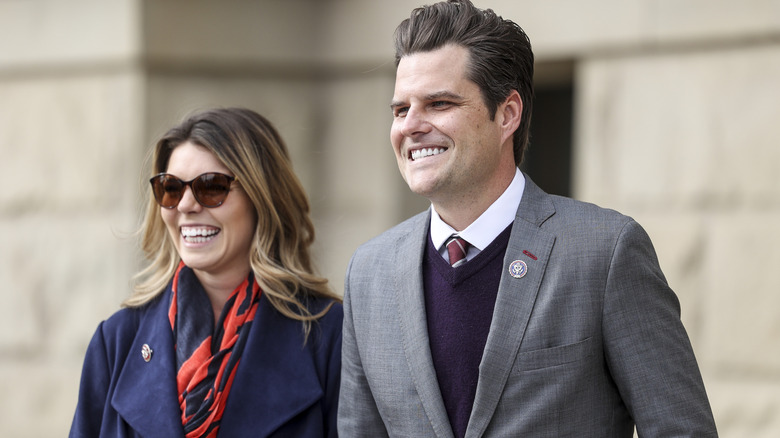 Matt Gaetz walking and smiling alongside Ginger Gaetz