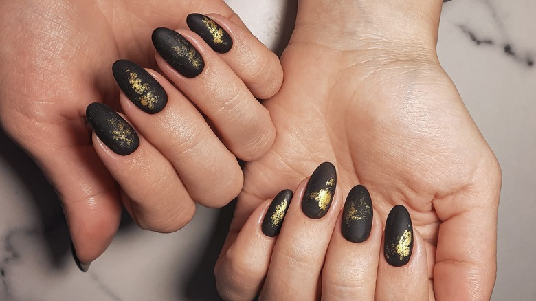 Matte black nails with gold flecks