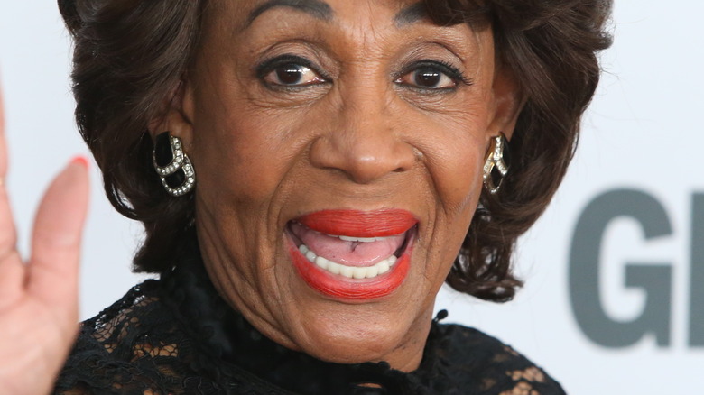 Maxine Waters smiling and waving