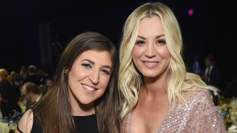 Mayim Bialik and Kaley Cuoco smiling in their gowns at an awards show
