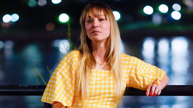 Kaley Cuoco posing in a checkered yellow dress in 2021