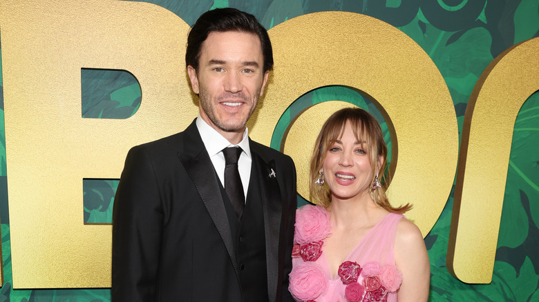 Elegantly dressed Tom Pelphrey and Kaley Cuoco attending a premiere in 2022