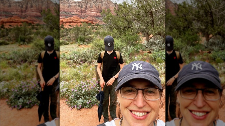 Mayim Bialik smiling in a selfie with her son Miles standing in background