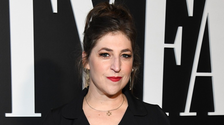 Mayim Bialik smiling in red lipstick