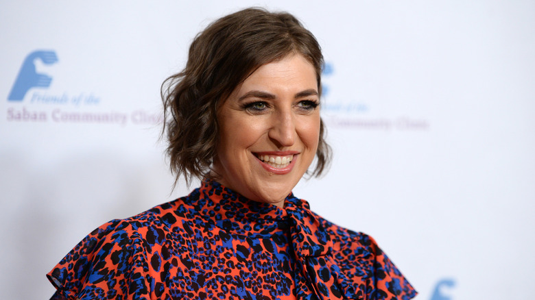 Mayim Bialik in an orange-and-blue leopard top