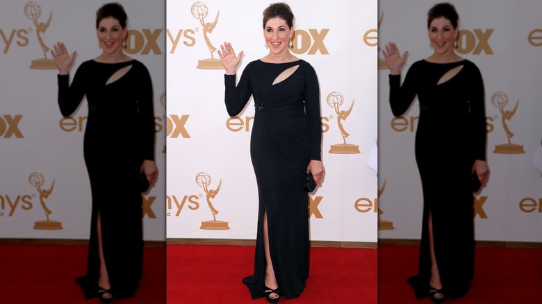 Mayim Bialik waves while walking the red carpet at the 2011 Emmys