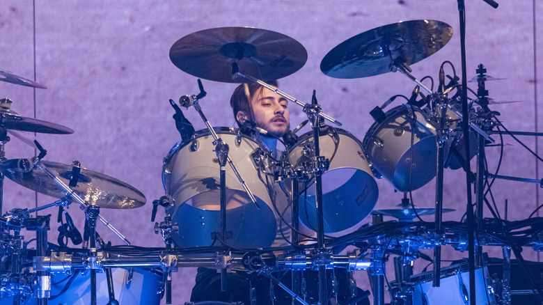 Nic Collins playing the drums in 2021.