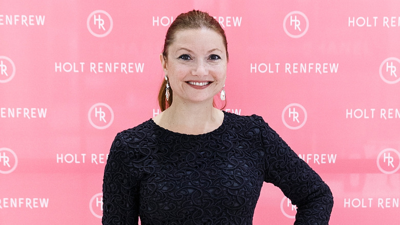 Joely Collins posing at an event in 2014.