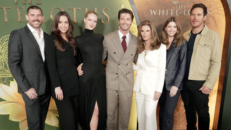 Arnold Schwarzenegger's children posing for photos with their partners and Maria Shriver