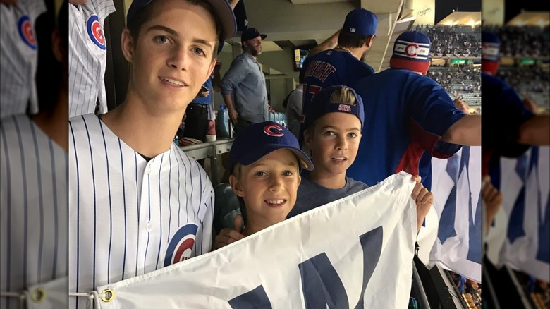 Chip, Charlie, and Finley O'Donnell smiling at a baseball game