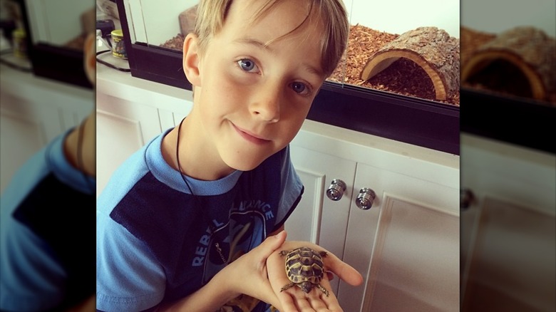 Finley O'Donnell holding a baby turtle
