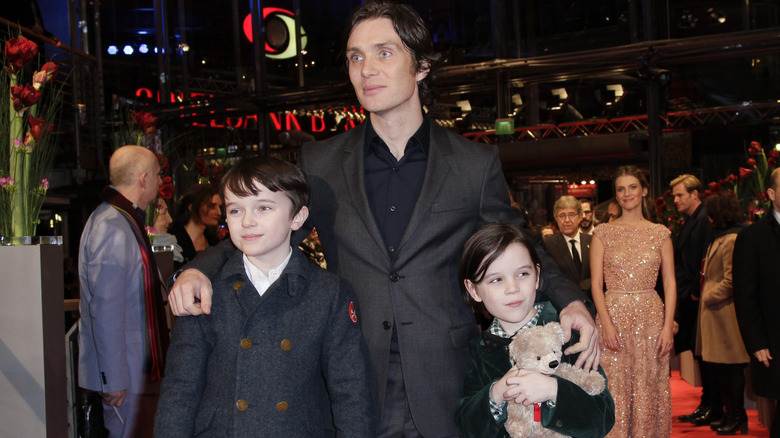 Cillian Murphy between Malachy and Aran at event