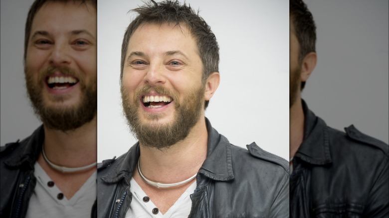 Duncan Jones laughing in a black leather jacket