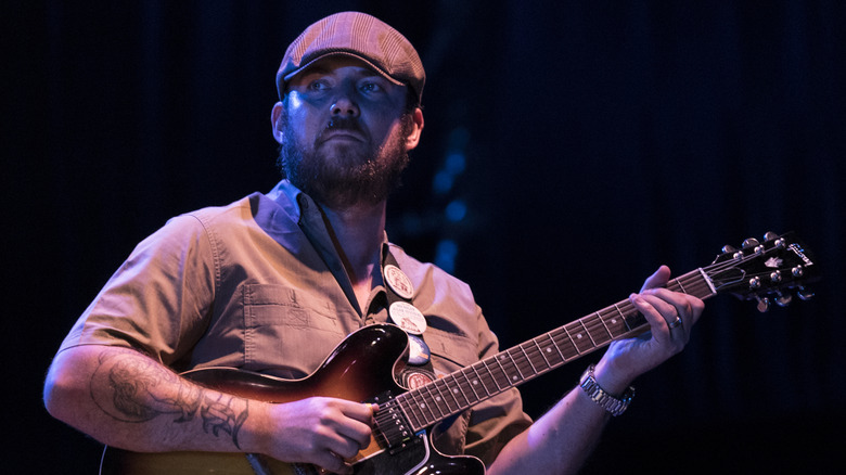 Jackson Smith looking serious and playing guitar