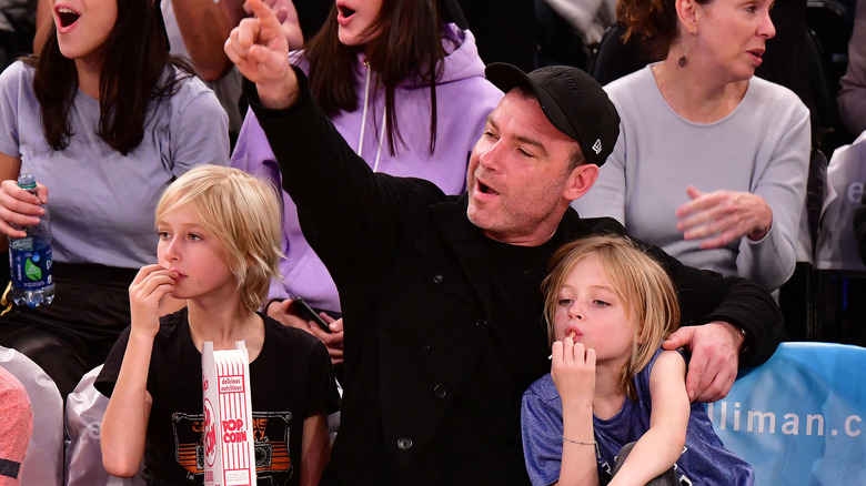Liev Schreiber attending a sporting event with his children
