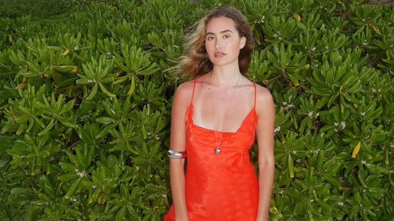 Alexandra Lamas posing in a coral dress on her 2026 trip to Tulum