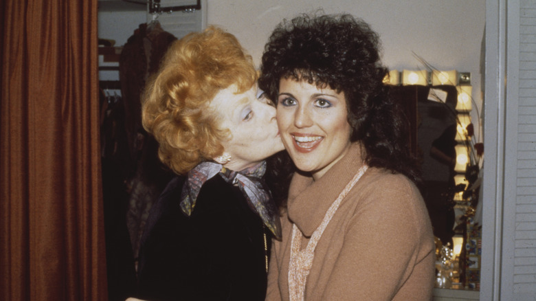 Lucille Ball kissing Lucie Arnaz on the cheek,
