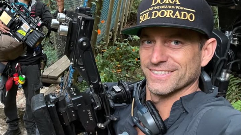 Christian Gibson posing in jungle with camera equipment