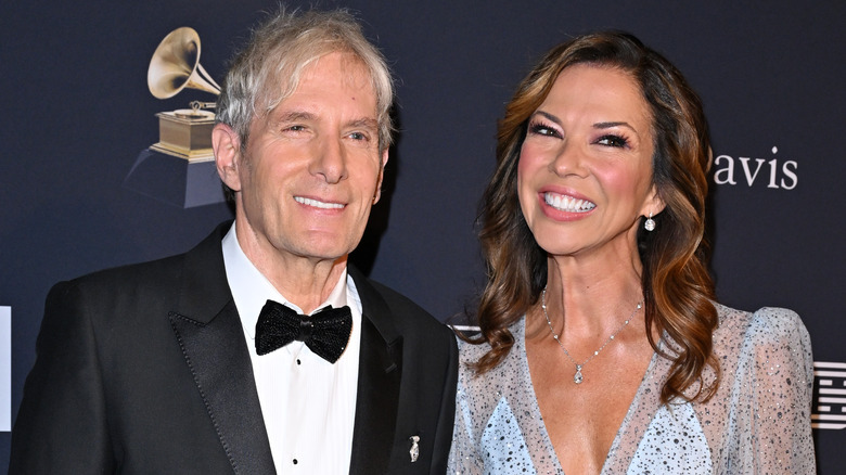 Michael Bolton and Heather Kerzner smiling on red carpet