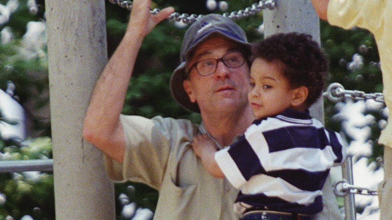 Robert De Niro holding a young Elliot