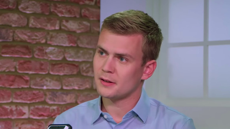 George Farmer speaking into microphone