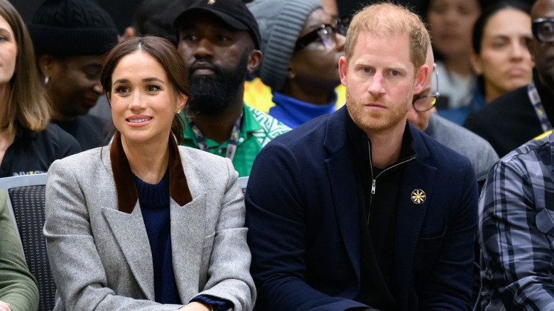 Meghan Markle and Prince Harry watching a game