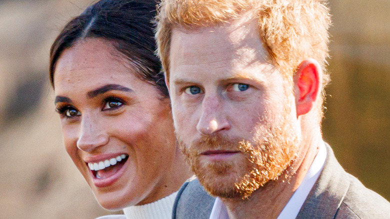 Meghan and Harry smile and greet fans