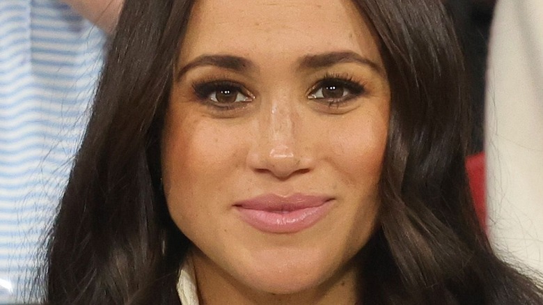 Meghan Markle smiles at an event