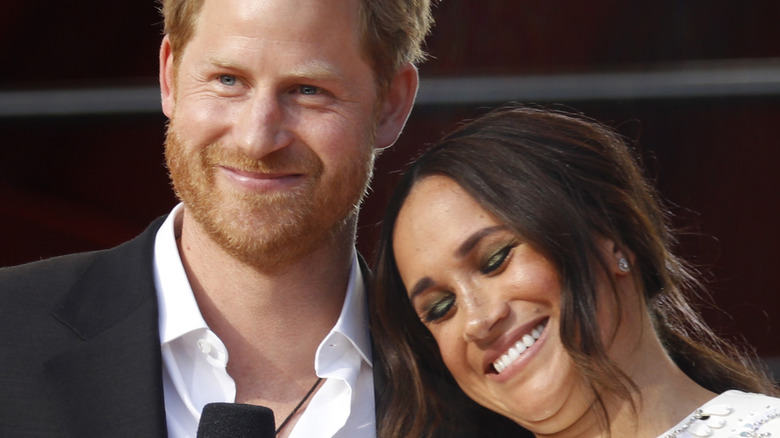 Prince Harry & Meghan Markle smiling