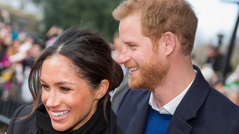 Prince Harry holding Meghan Markle in public 