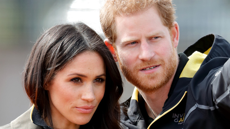 Prince Harry points something out to Meghan Markle