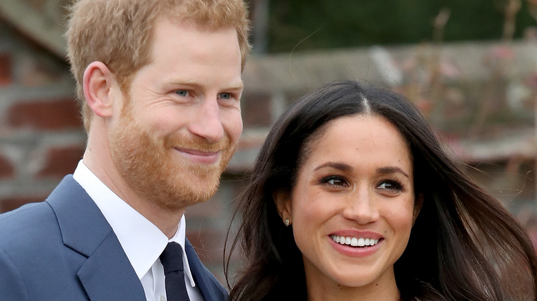 Meghan Markle and Prince Harry smiling during engagement photo