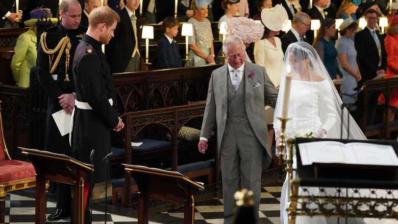 Prince Charles escorting Meghan Markle to Harry at their wedding