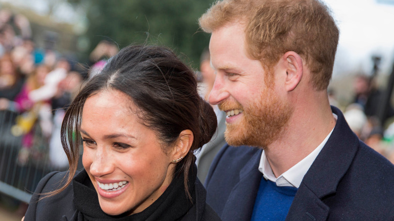 Meghan Markle and Prince Harry greeting fans