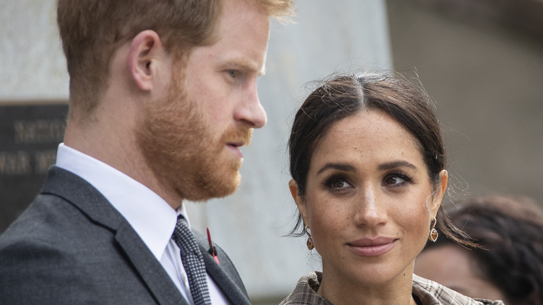 Prince Harry and Meghan Markle looking serious