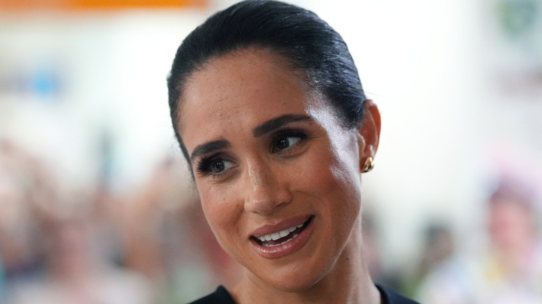 Meghan Markle hair pulled back and head tilted to one side