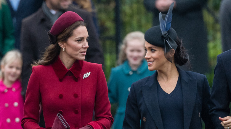 Kate Middleton talking to Meghan Markle