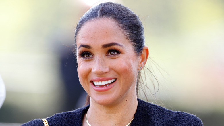 Meghan Markle smiling outside