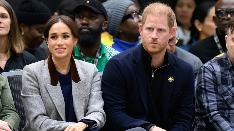 Prince Harry and Meghan Markle looking uncomfortable.