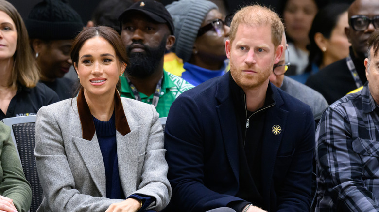 Prince Harry and Meghan Markle looking uncomfortable.
