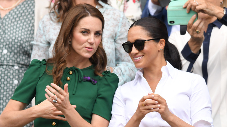 Kate Middleton talking to Meghan Markle