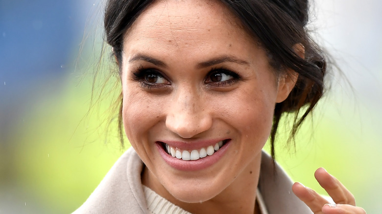 Meghan Markle waving coyly