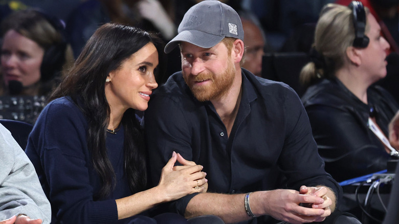 Meghan Markle and Prince Harry leaning in and talking to each other