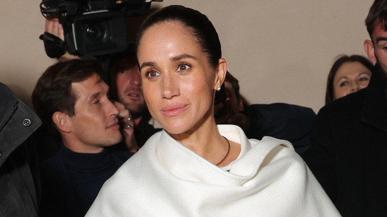 Meghan Markle smiling in white