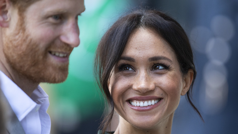 Meghan Markle smiling up at Prince Harry