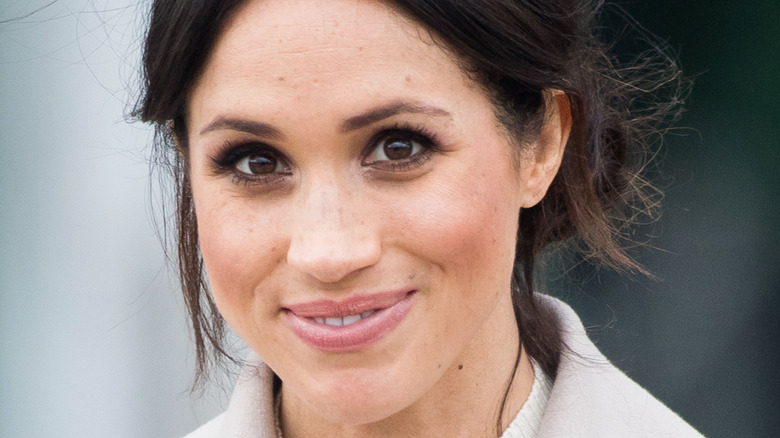 Meghan Markle smiles at an event