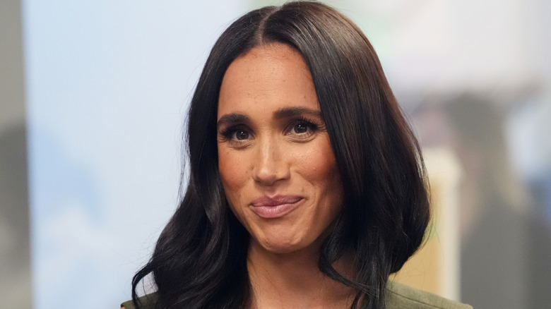 Meghan Markle smiling green top