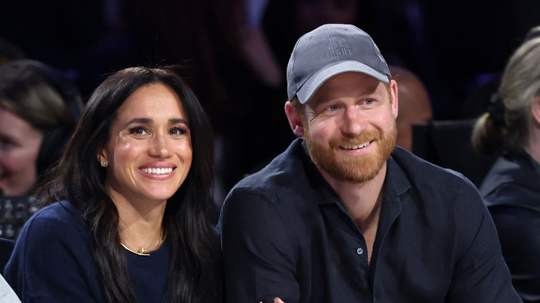 Meghan Markle and Prince Harry watching a basketball game