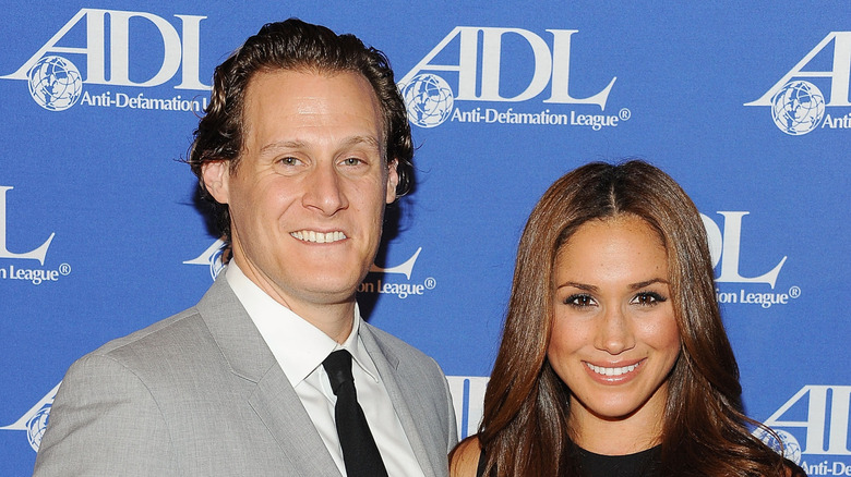Meghan Markle and Trevor Engelson posing for photos together at an event
