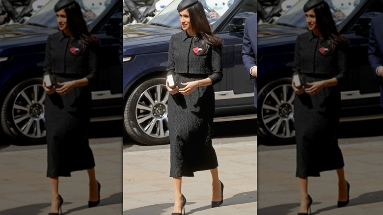 Meghan Markle smiling and walking